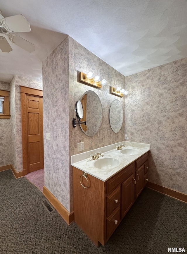 290 W Railroad St, Roseville, IL 61473 - bathroom with wallpapered walls, a sink, double vanity, and visible vents