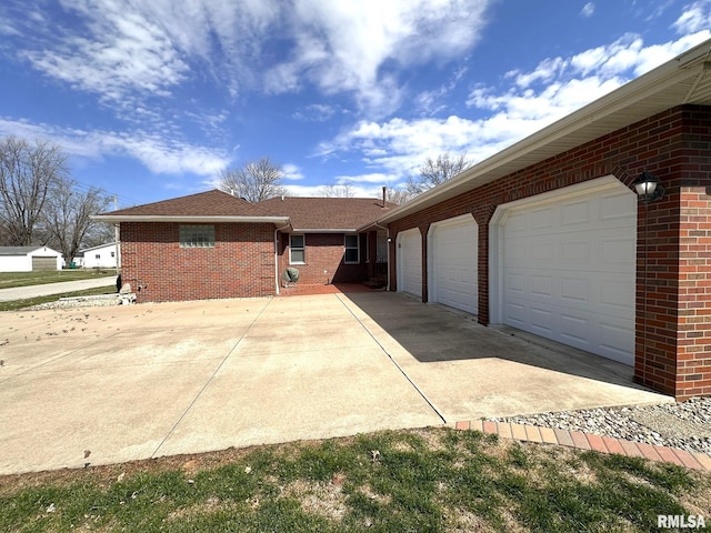 290 W Railroad St, Roseville, IL 61473 - view of home's exterior with brick siding, concrete driveway, a shingled roof, and an attached garage