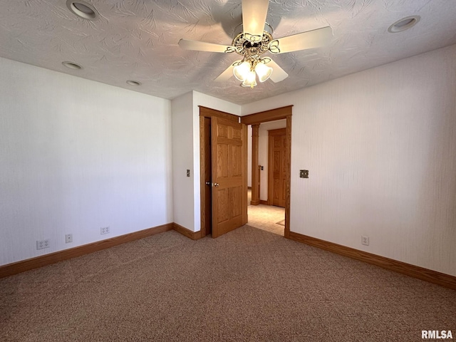 290 W Railroad St, Roseville, IL 61473 - carpeted spare room with baseboards, a textured ceiling, and a ceiling fan
