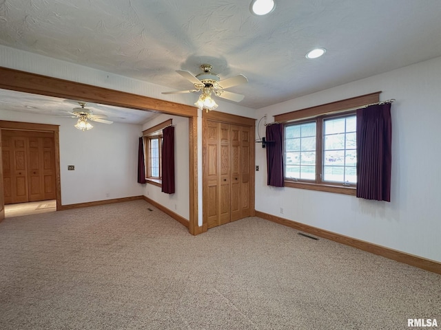 290 W Railroad St, Roseville, IL 61473 - empty room with a ceiling fan, baseboards, light colored carpet, and visible vents