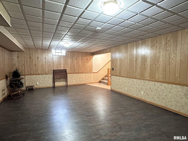 290 W Railroad St, Roseville, IL 61473 - below grade area with wood walls, stairway, a drop ceiling, wallpapered walls, and dark wood-style floors