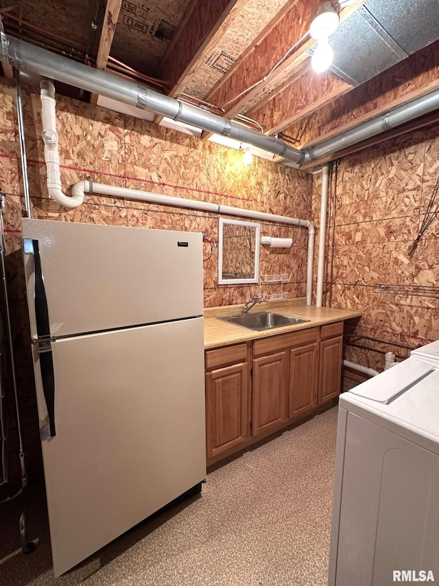 290 W Railroad St, Roseville, IL 61473 - kitchen featuring light countertops, washer / clothes dryer, brown cabinets, a sink, and freestanding refrigerator