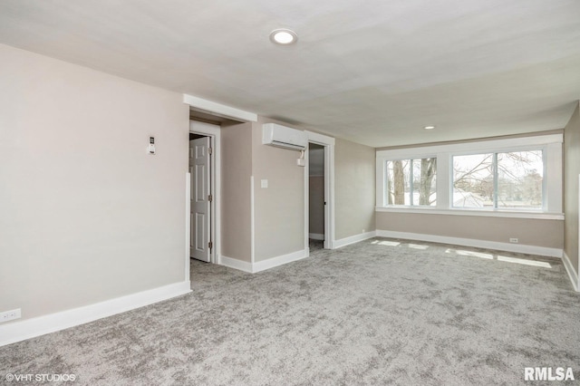 418 4th St, Illiopolis, IL 62539 - carpeted spare room featuring baseboards, a wall mounted air conditioner, and recessed lighting