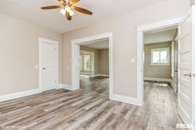 418 4th St, Illiopolis, IL 62539 - unfurnished room with baseboards, light wood-style floors, and ceiling fan