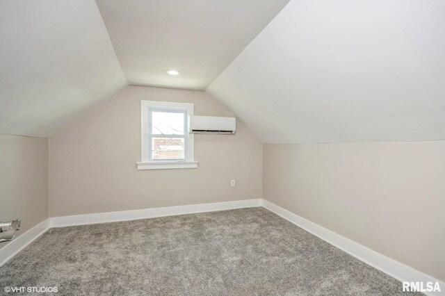 418 4th St, Illiopolis, IL 62539 - additional living space with baseboards, vaulted ceiling, a wall mounted air conditioner, and carpet flooring
