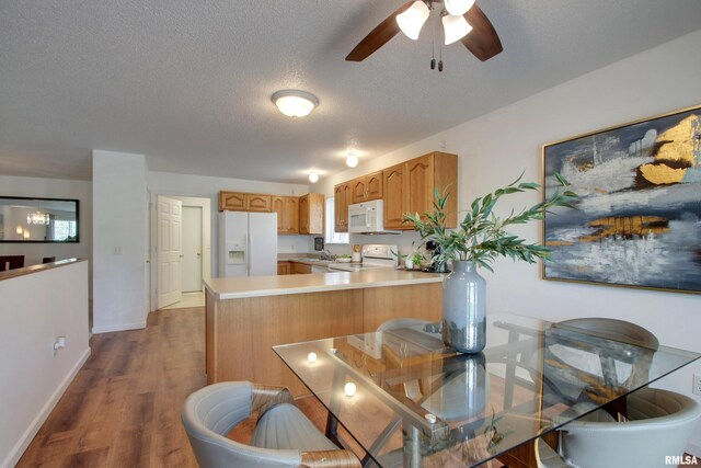 4804 Elm St, Quincy, IL 62305 - kitchen with white appliances, a peninsula, light countertops, a ceiling fan, and a sink