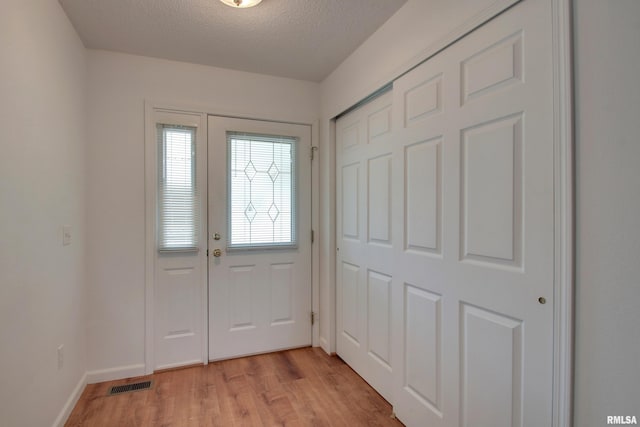 4804 Elm St, Quincy, IL 62305 - entrance foyer featuring light wood finished floors, baseboards, and a textured ceiling