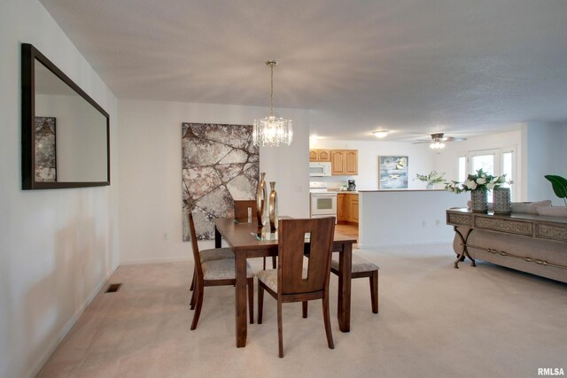4804 Elm St, Quincy, IL 62305 - dining space featuring light colored carpet, a chandelier, baseboards, and a ceiling fan