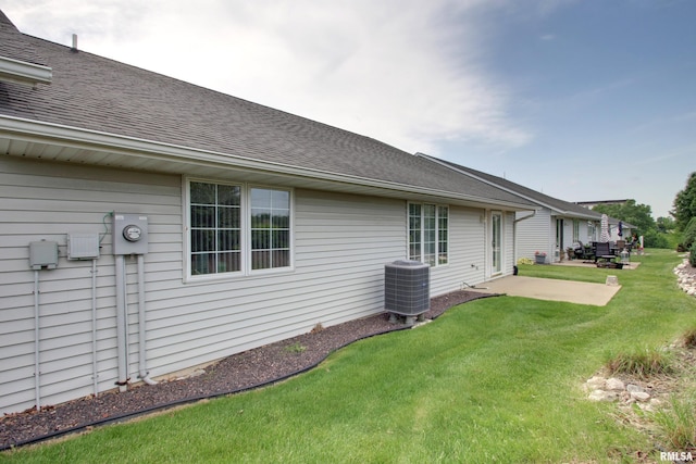 4804 Elm St, Quincy, IL 62305 - back of property featuring cooling unit, a yard, roof with shingles, and a patio area