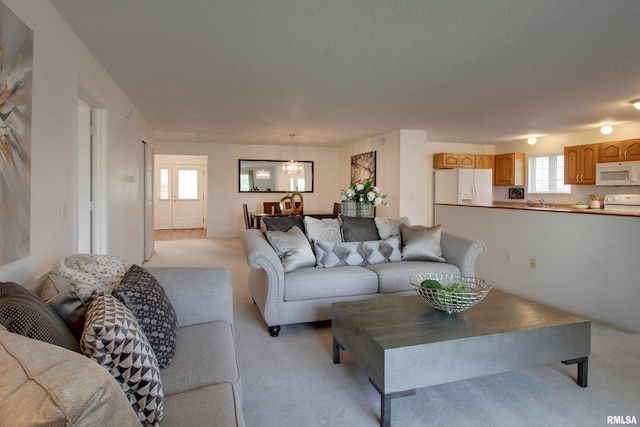 4804 Elm St, Quincy, IL 62305 - living area featuring light carpet and a chandelier