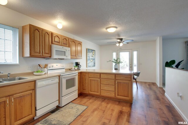 4804 Elm St, Quincy, IL 62305 - kitchen featuring white appliances, a textured ceiling, a sink, light countertops, and a peninsula