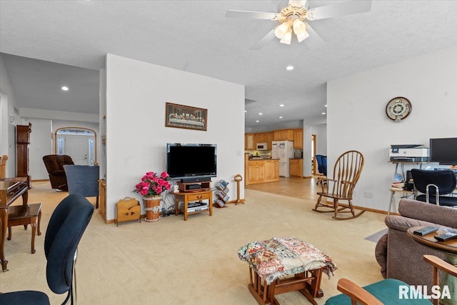 living room with light carpet, ceiling fan, recessed lighting, and a textured ceiling