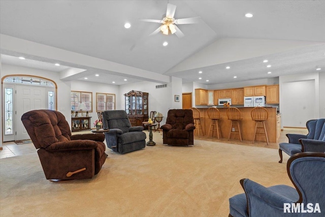 living area with light colored carpet, visible vents, high vaulted ceiling, and recessed lighting