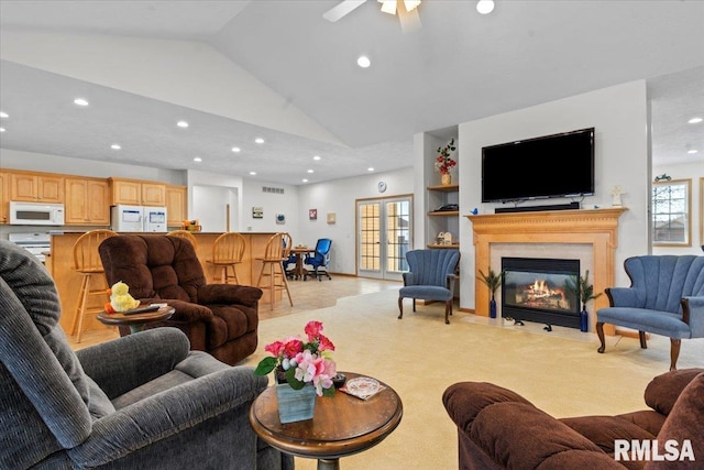 living area with a fireplace with flush hearth, visible vents, and recessed lighting