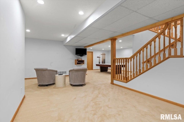 living area with baseboards, carpet flooring, and visible vents