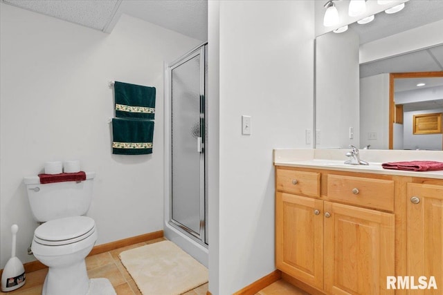 full bath with toilet, vanity, baseboards, and a shower stall