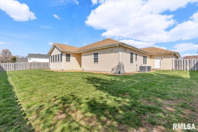 back of house featuring fence, cooling unit, and a yard