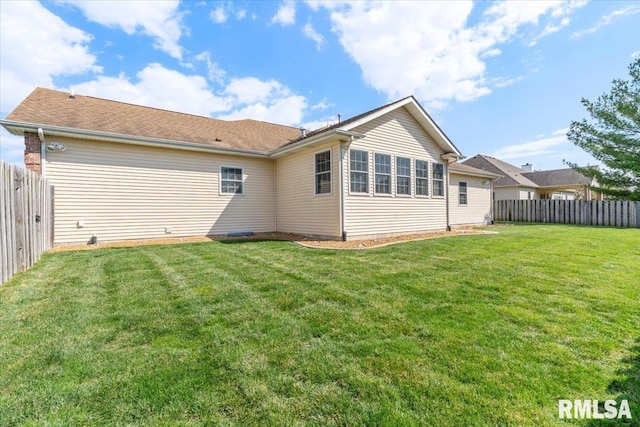 back of house featuring a fenced backyard and a yard