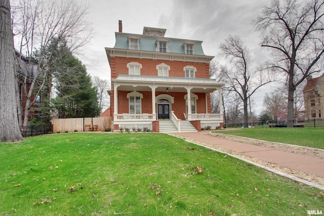 1477 Maine St, Quincy, IL 62301 - victorian home featuring covered porch, mansard roof, fence, and a front lawn