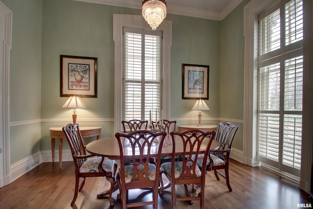 1477 Maine St, Quincy, IL 62301 - dining area featuring crown molding, wood finished floors, a notable chandelier, and plenty of natural light