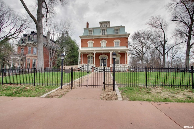 1477 Maine St, Quincy, IL 62301 - italianate home featuring a front yard, a porch, a gate, and a fenced front yard