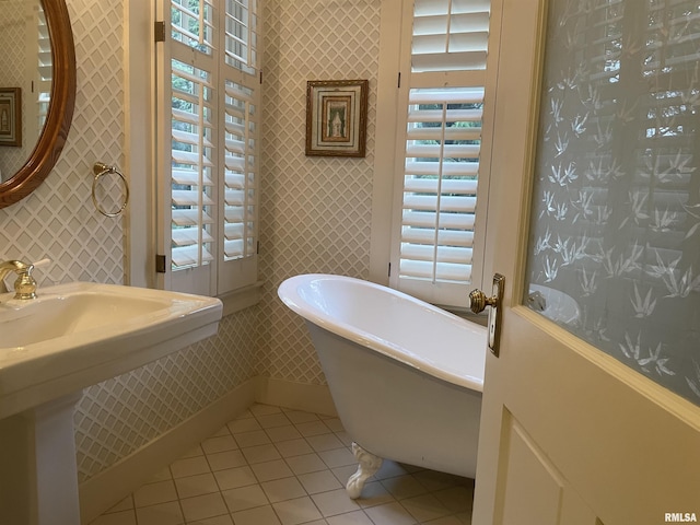 1477 Maine St, Quincy, IL 62301 - full bath with tile patterned floors, wallpapered walls, and a freestanding bath