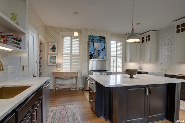 1477 Maine St, Quincy, IL 62301 - kitchen featuring white cabinetry, wallpapered walls, a sink, and dishwasher