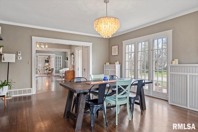 dining room featuring plenty of natural light, a notable chandelier, and visible vents
