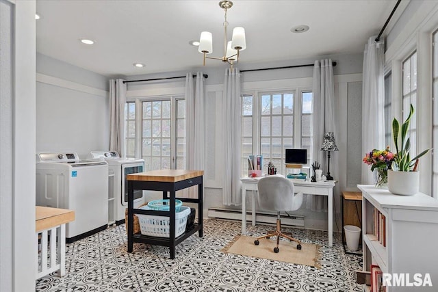 office area with a notable chandelier, washing machine and clothes dryer, a baseboard heating unit, and a wealth of natural light