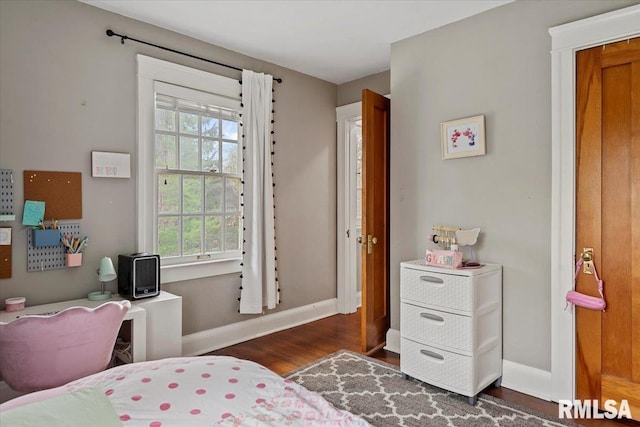 bedroom with dark wood-style flooring and baseboards