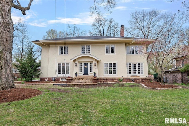 back of house with a chimney, french doors, stucco siding, and a lawn