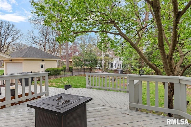 deck with fence, a fire pit, and a lawn