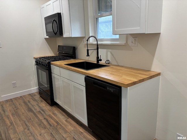 kitchen featuring a sink, white cabinets, wooden counters, dark wood finished floors, and black appliances