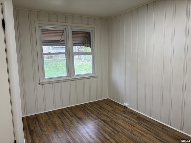 unfurnished room featuring dark wood-type flooring