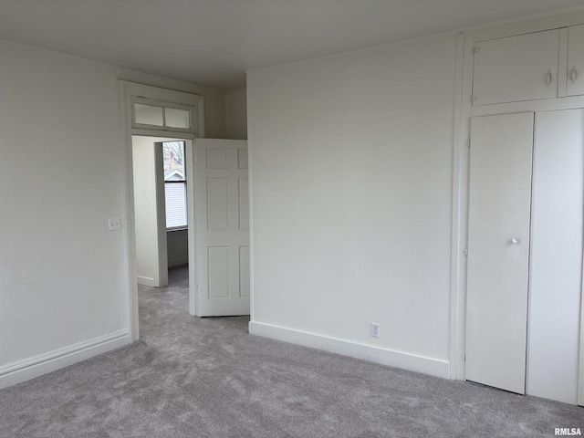 unfurnished room featuring baseboards and carpet flooring