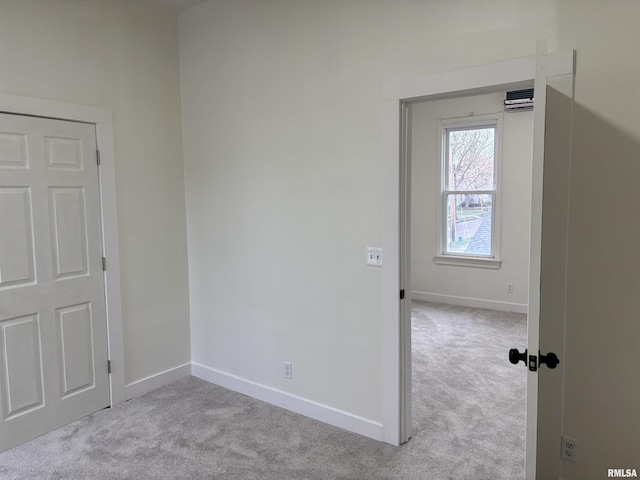 unfurnished bedroom with baseboards and carpet