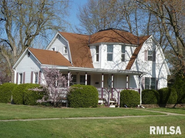view of front of home with a gambrel roof, covered porch, and a front lawn
