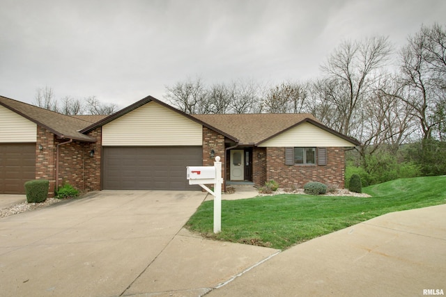 624 Pawn Ave, Quincy, IL 62305 - single story home featuring a front yard, a garage, concrete driveway, brick siding, and roof with shingles