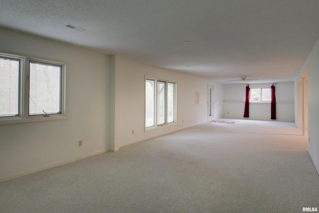 624 Pawn Ave, Quincy, IL 62305 - spare room with a textured ceiling, baseboards, a ceiling fan, and carpet floors