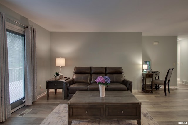 624 Pawn Ave, Quincy, IL 62305 - living room with visible vents, baseboards, and light wood finished floors