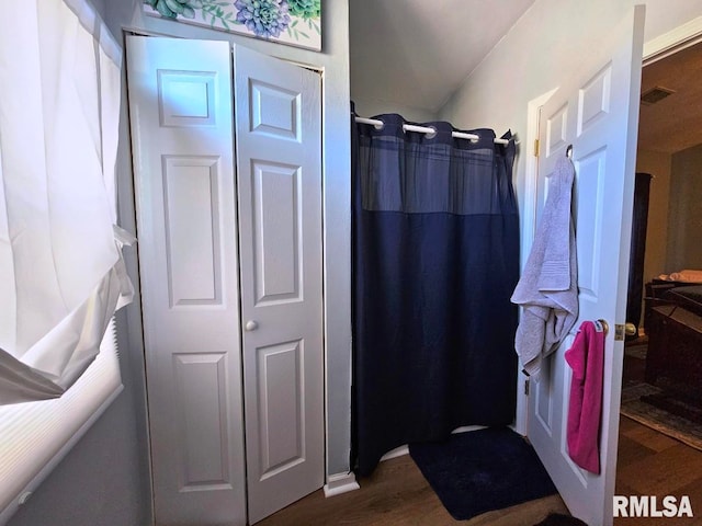 bathroom with visible vents, wood finished floors, and a shower with shower curtain