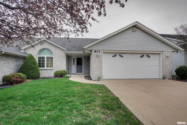 812 N 49th St, Quincy, IL 62305 - ranch-style house featuring brick siding, an attached garage, and driveway