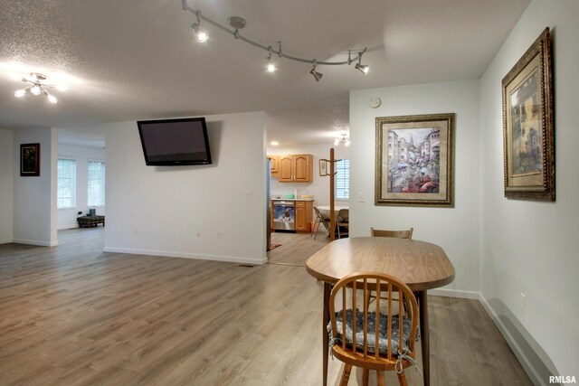 812 N 49th St, Quincy, IL 62305 - dining room featuring a textured ceiling, light wood finished floors, and baseboards