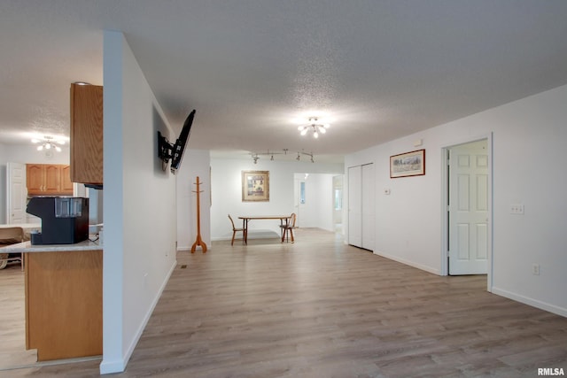 812 N 49th St, Quincy, IL 62305 - interior space featuring baseboards, light wood-type flooring, and a textured ceiling