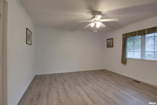 812 N 49th St, Quincy, IL 62305 - empty room featuring visible vents, baseboards, a ceiling fan, a textured ceiling, and light wood finished floors