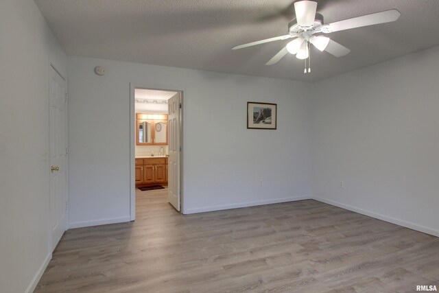 812 N 49th St, Quincy, IL 62305 - unfurnished room with light wood-style flooring, a textured ceiling, ceiling fan, and baseboards