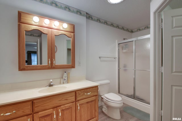 812 N 49th St, Quincy, IL 62305 - full bath featuring toilet, a shower stall, vanity, and a textured ceiling