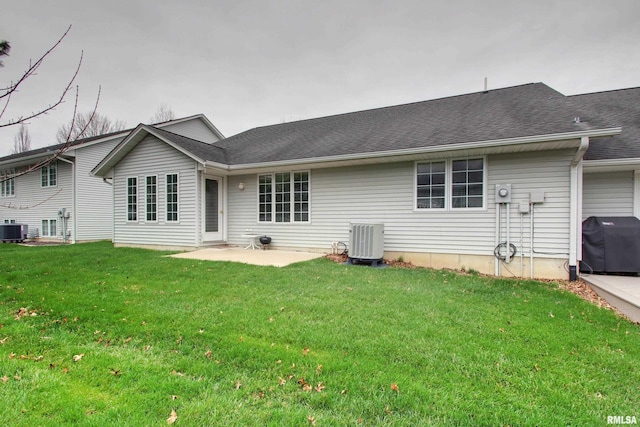 812 N 49th St, Quincy, IL 62305 - rear view of house with roof with shingles, a lawn, a patio area, and central AC