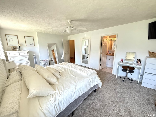 104 W Waterford Dr, Quincy, IL 62305 - carpeted bedroom featuring ensuite bathroom, a textured ceiling, baseboards, and ceiling fan
