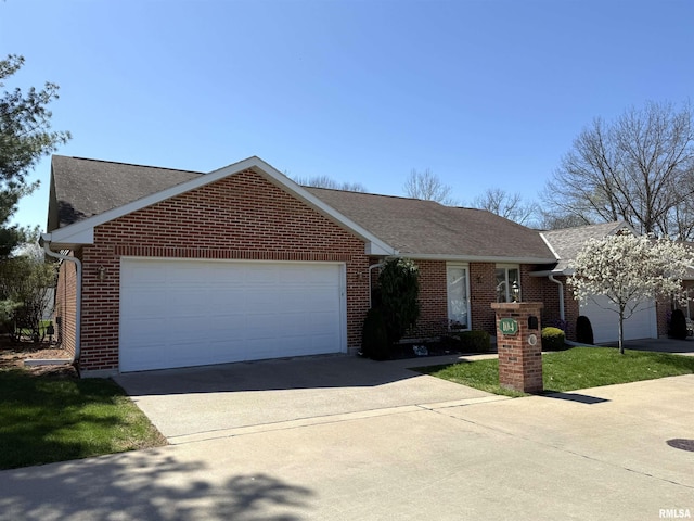104 W Waterford Dr, Quincy, IL 62305 - single story home with brick siding, roof with shingles, a garage, and concrete driveway